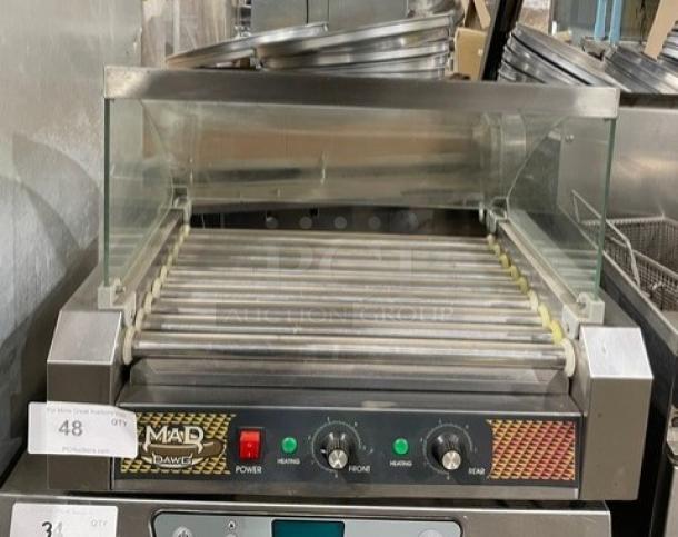 Great Northern Popcorn Mad Dog 4330 hotdog machine, 9 stainless steel rollers, tempered glass sneeze guard, excellent condition.
