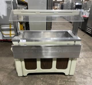 Custom buffet style stainless steel refrigerated salad bar with sneeze guard, folding tray slide, on casters.