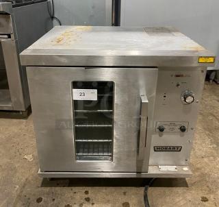 Hobart CN85 commercial stainless steel countertop convection oven, thermostatic control, wired rack, 208V, on legs.