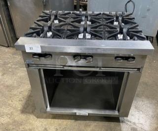 U.S. Range commercial stainless steel 6-burner gas range with dry cabinet storage, on casters. Good condition.