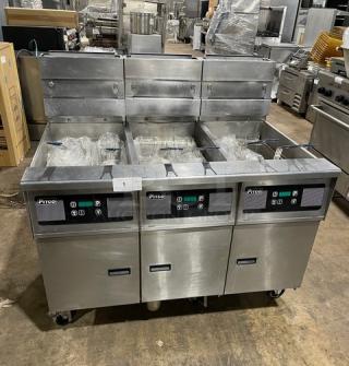 Pitco SG14-JS stainless steel 40 lb. triple-bay fryer system with digital control, backsplash, basket hanger, and caster wheels.