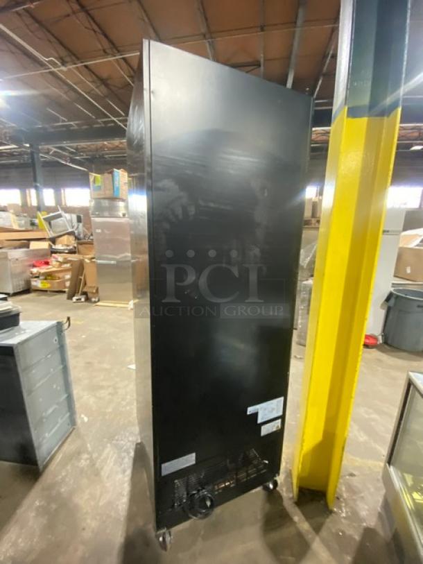 Avantco Commercial Black Glass Door Merchandiser Refrigerator, model 178GDC23HCB, on casters with poly-coated wire rack, SN: 6464310517030584.