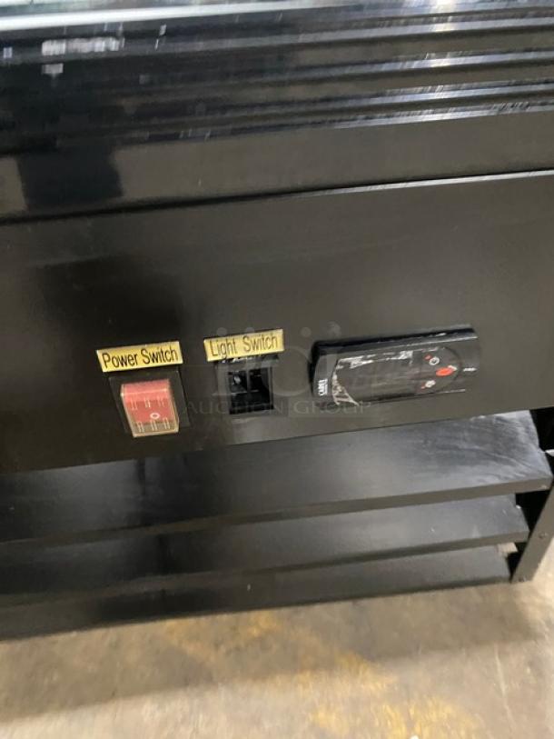 Avantco Commercial Black Reach-In Merchandiser Refrigerator, model 178GDC23HCB, with power and light switches visible.