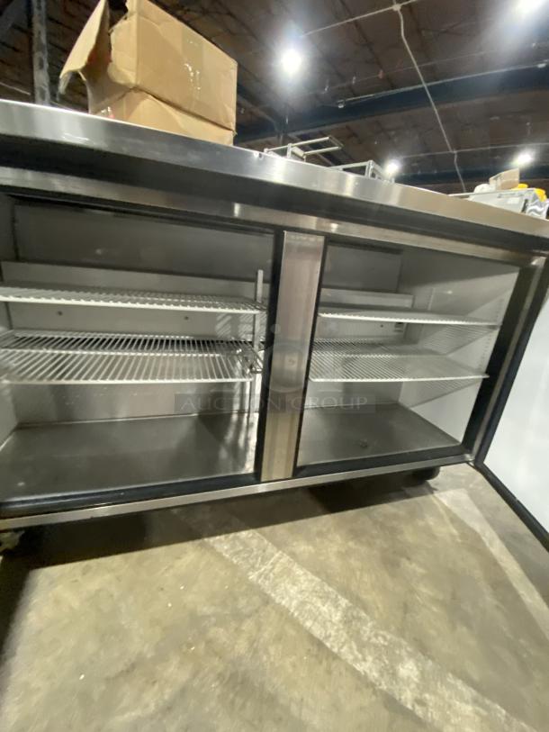 True TWT-60 stainless steel 2-door worktop/undercounter refrigerator with backsplash, poly coated racks, on casters.