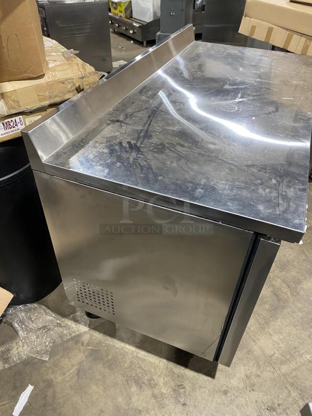 True TWT-60 stainless steel 2-door undercounter refrigerator with backsplash, poly-coated rack, and casters. Energy Star certified.