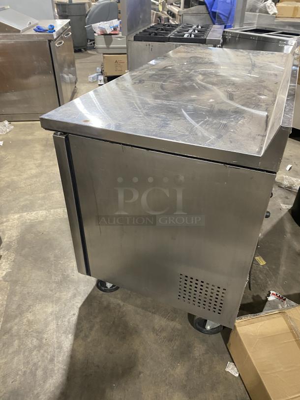 True TWT-60 stainless steel 2-door worktop undercounter refrigerator, Energy Star certified, on casters, with backsplash and poly coated wire rack.