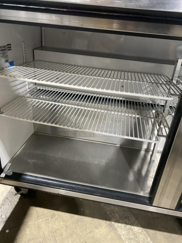 True TWT-60 stainless steel 2-door worktop table/undercounter refrigerator, Energy Star certified, with backsplash, poly-coated wire racks, on casters.