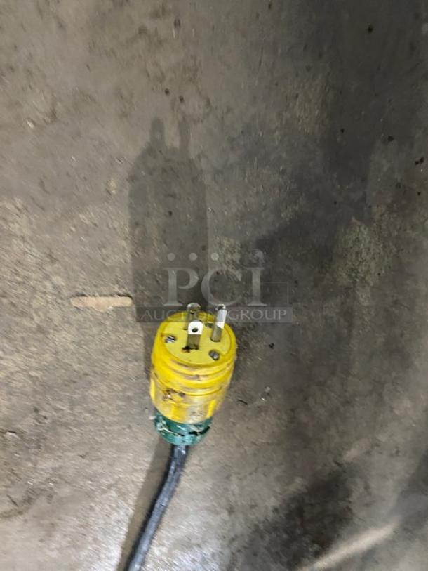 A yellow electrical plug on a dark surface, not directly related to the auction item described.