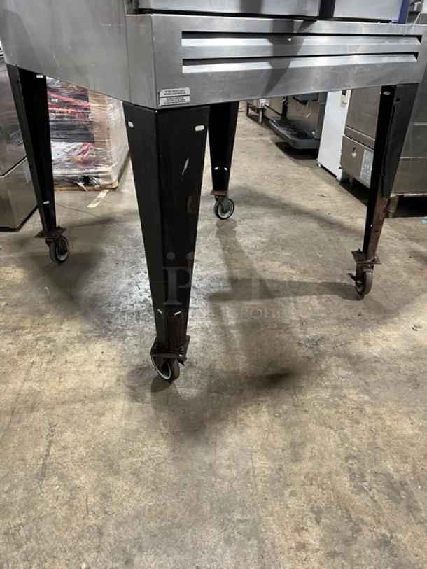 Bakers Pride GDCO-E1 electric convection oven on casters, shown from a lower angle, highlighting sturdy black legs.