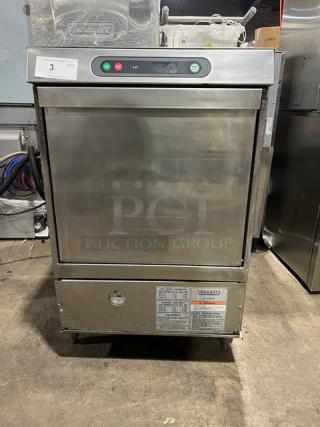 Hobart LXi series stainless steel electric undercounter dishwasher on legs. Visible control panel, warning labels, sturdy condition.