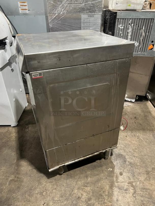 Hobart LXi Series commercial undercounter dishwasher, stainless steel, electric, on legs. Signs of wear visible.