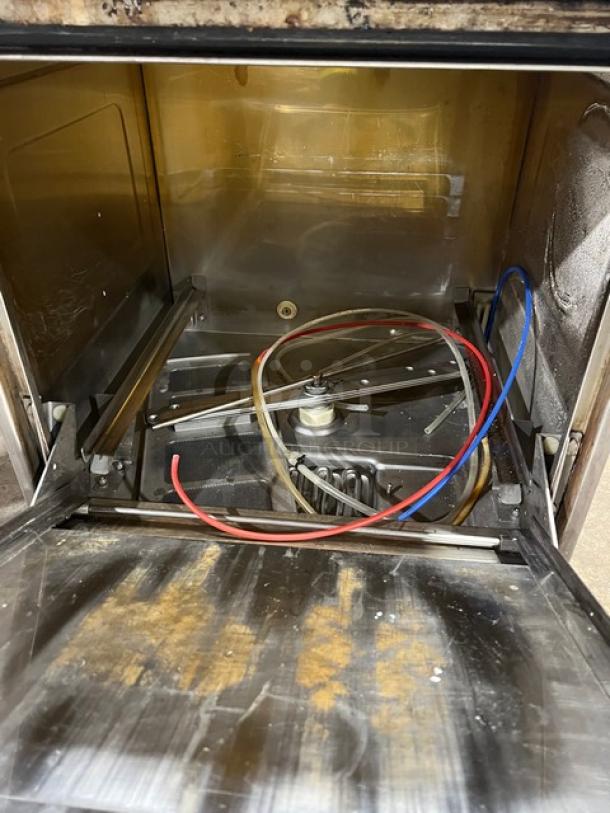 Hobart LXi Series undercounter dishwasher, electric-powered, stainless steel, interior view showing spray arms and hoses.