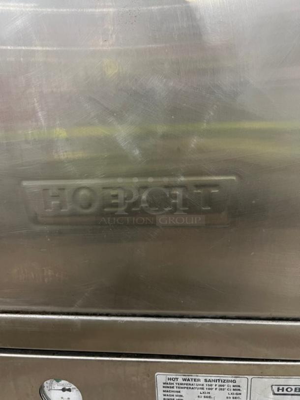 Hobart LXi Series stainless steel undercounter dishwasher, electric powered, on legs. Visible Hobart logo indicates brand.