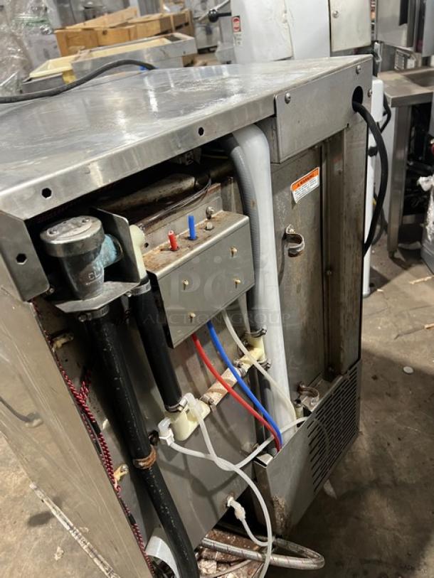 Hobart LXi Series stainless steel undercounter dishwasher, electric-powered, visible plumbing and wiring, on legs, used condition.