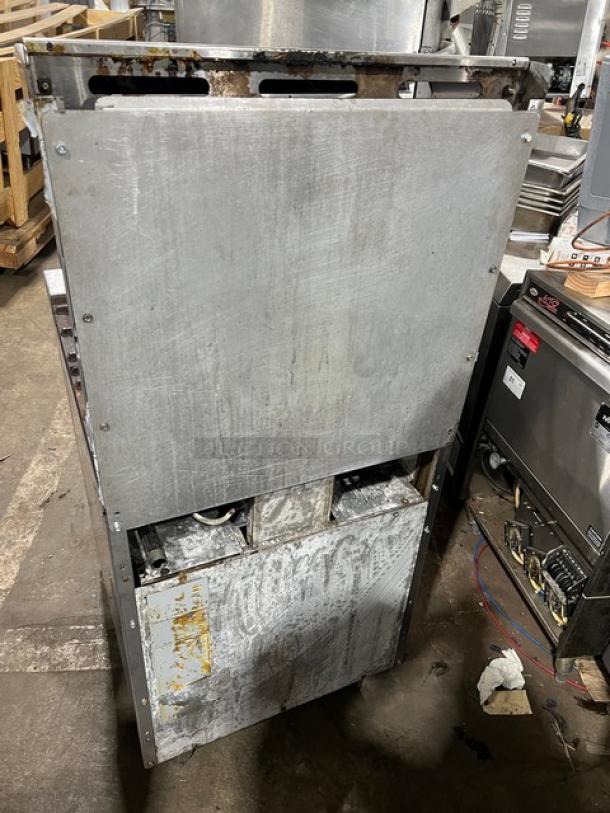 American Range commercial stainless steel 4-burner range/oven combo. Features natural gas power, backsplash, salamander shelf, and legs. Signs of wear and usage visible.