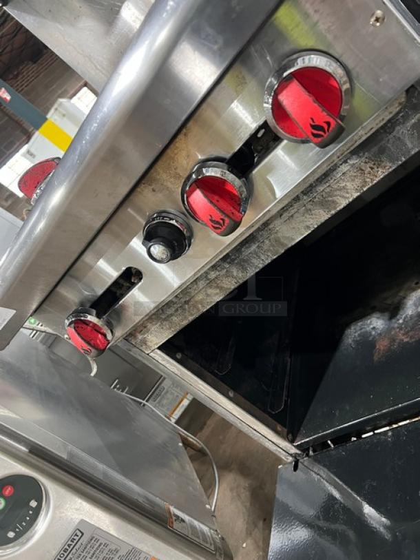 American Range stainless steel 4-burner range/oven combo with backsplash. Features overhead salamander shelf. Natural gas powered.