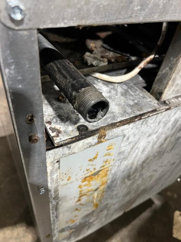 American Range commercial 4-burner stainless steel range/oven, highlighted detail of rear side. Natural gas powered.