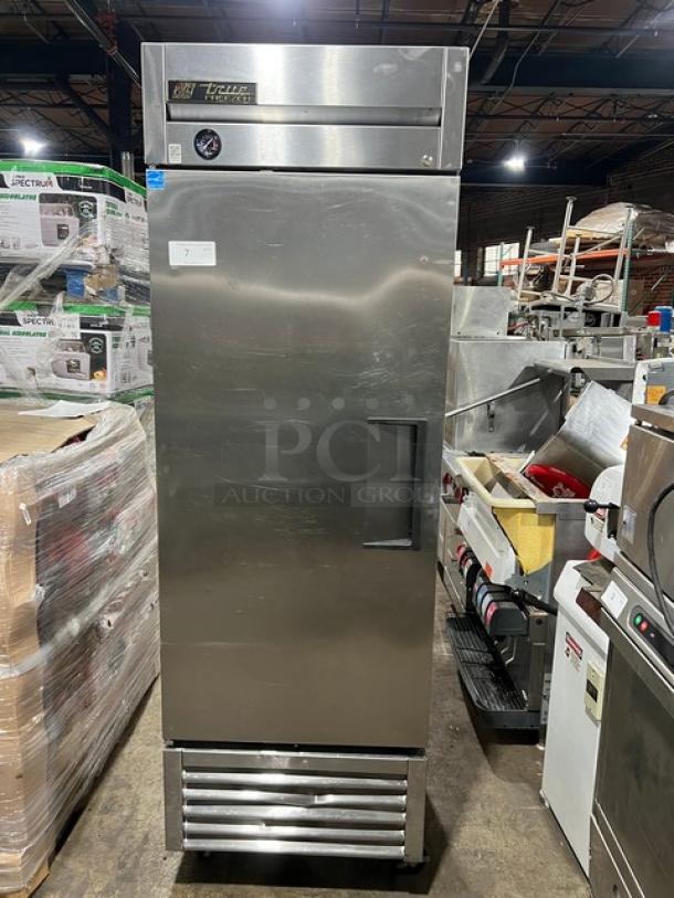 True T-23F commercial stainless steel single door reach-in freezer with poly coated wired rack, Energy Star certified, on casters.