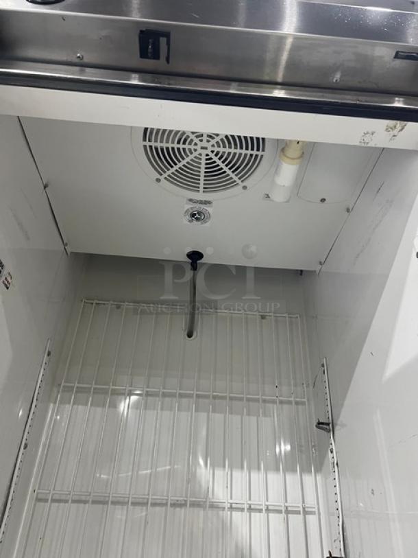 True Commercial Stainless Steel Reach-In Freezer T-23F, Energy Star Certified, with poly-coated wire rack, on casters.