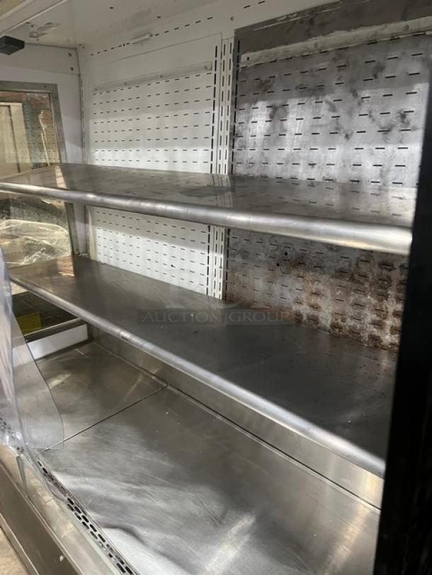 Federal Industries RSSD678SC5 commercial black open-air refrigerated merchandiser. Three adjustable shelves, visible wear.