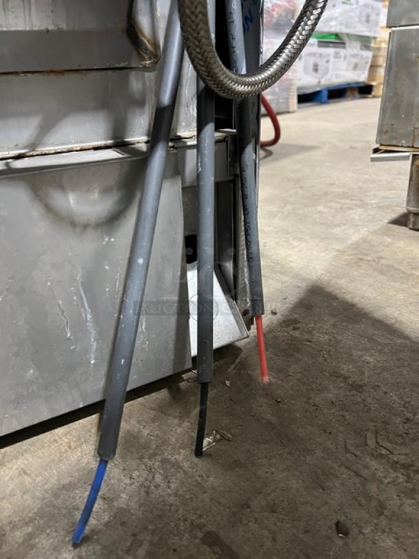 Hobart Advansys LXe Series commercial dishwasher. Stainless steel, undercounter model, visible power cables, appears used.