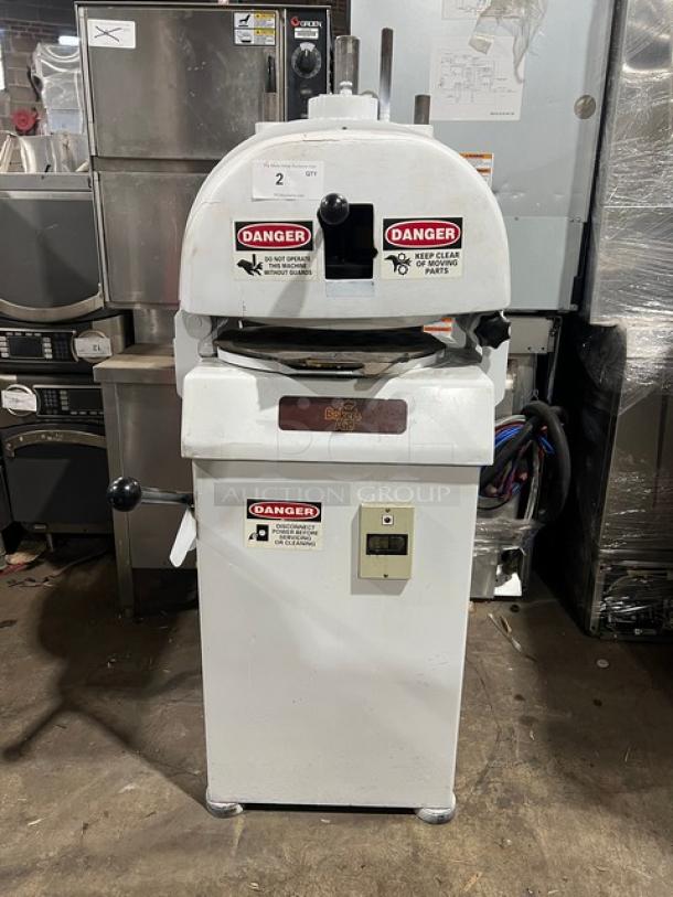 Baker's Aid commercial white semi-automatic dough divider/rounder machine on legs. Features multiple warning labels, electric powered.