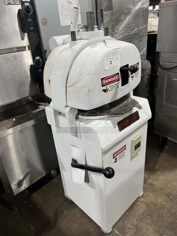 Baker's Aid white electric dough divider/rounder machine, on legs, with control panel and safety labels visible. Slight wear.