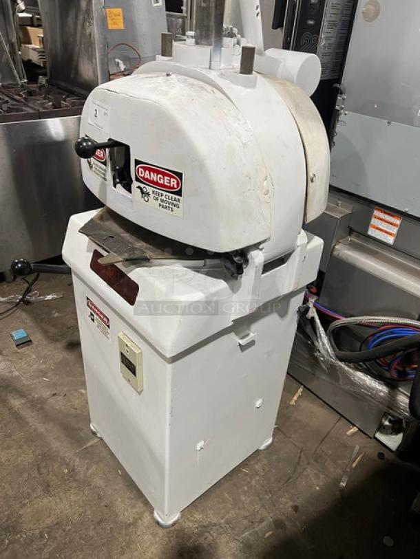 Baker's Aid white electric floor model semi-automatic dough divider/rounder machine, on legs, with safety warnings.