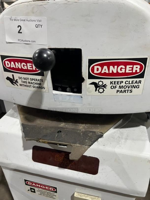 Baker's Aid commercial electric dough divider/rounder machine, white, on legs, warning labels on front, semi-automatic.