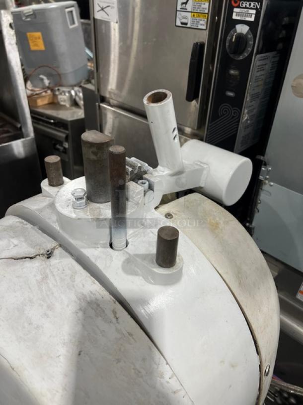 Baker's Aid white commercial electric dough divider/rounder machine with sturdy legs, visible levers, and industrial design.