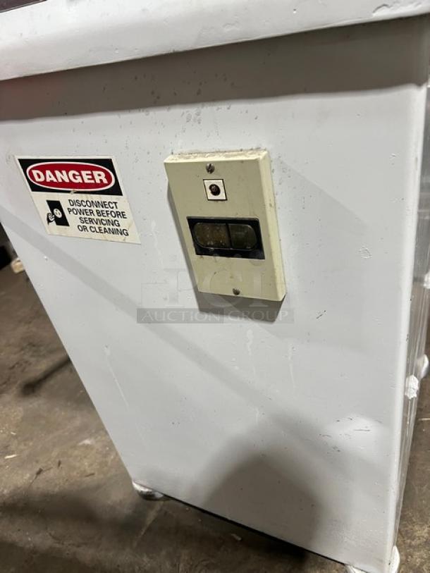 Baker's Aid white floor model dough divider/rounder machine, electric, semi-automatic, on legs, with power switch and "Danger" sticker.