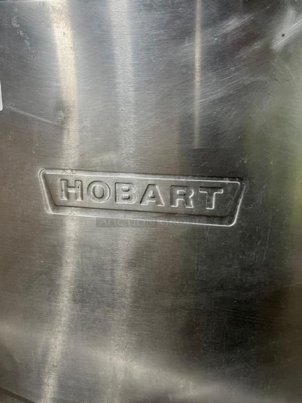 Hobart Advansys stainless steel ware washing machine, electric, door-type, on legs, embossed logo visible, commercial use.