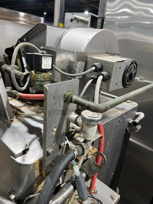 Hobart Advansys Series commercial ware washing machine, stainless steel, electric-powered, visible pipes and motor components, on legs.