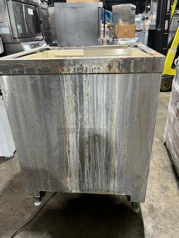 Cornelius ED200 Stainless Steel 8-Flavor Post-Mix Beverage/Ice Dispenser, rusted exterior, drip tray, self-serve levers, on legs.