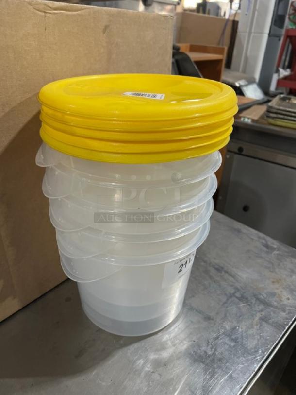 Rubbermaid Commercial 6 Qt. clear polycarbonate food storage container with yellow lid, new condition, stackable design.