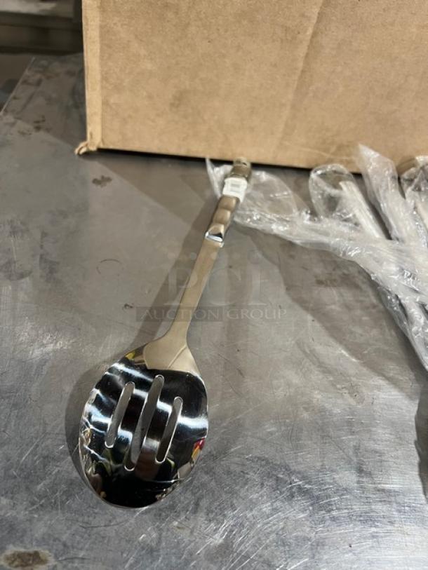 Update International 11.75" stainless steel slotted serving spoon, Model HB-2/PH, shown new in packaging with cardboard box.