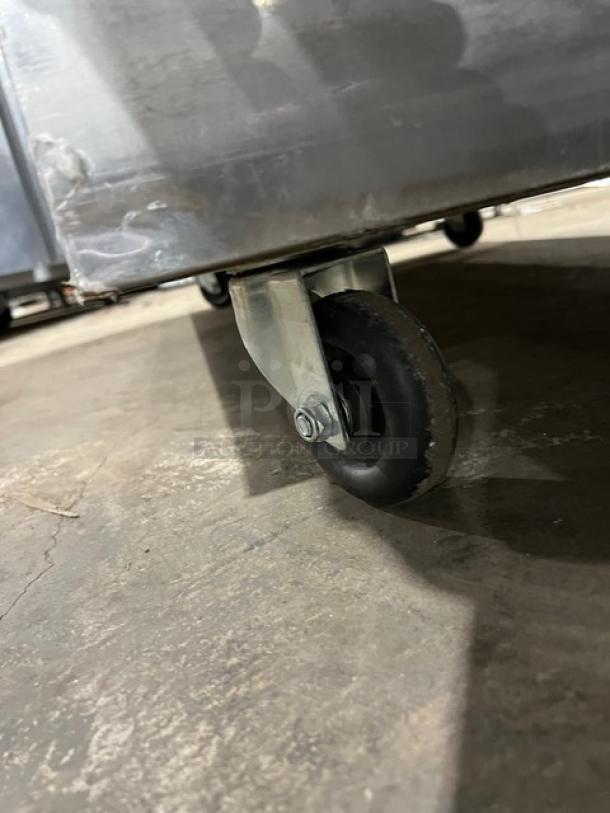 Migali C2F commercial stainless steel freezer caster wheel detail, showcasing sturdy construction. Model C-2F, on casters for mobility.