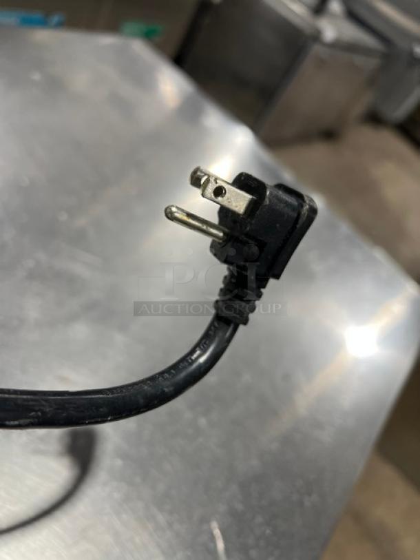 Alt text: Atosa MGF8408GR commercial stainless steel worktop refrigerator plug detail, on casters, with poly-coated wire rack.