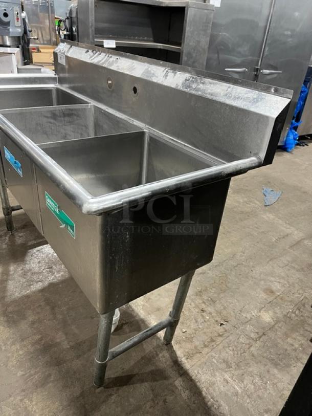 KCS stainless steel 3-compartment dishwashing sink with backsplash and legs. Commercial-grade, used condition.