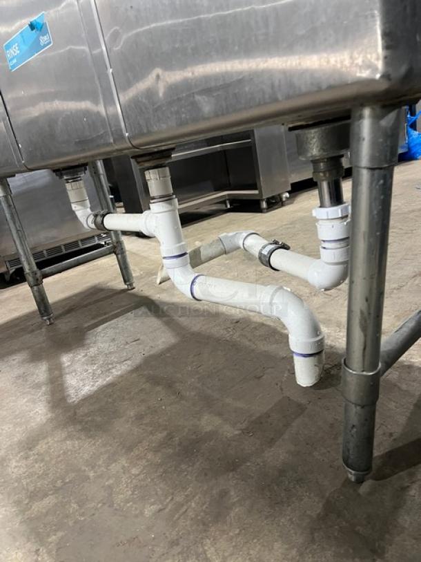 KCS stainless steel 3-compartment sink with backsplash on legs, showing plumbing connections.