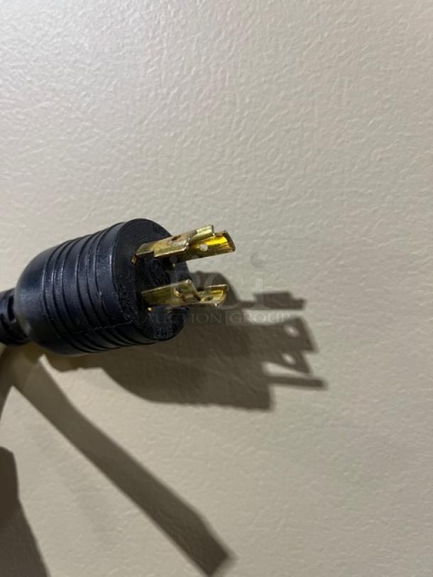 Close-up of a plug from the Master-Bilt BLG74HD commercial refrigerator, model equipped for 115/208-230V 1 Phase power.