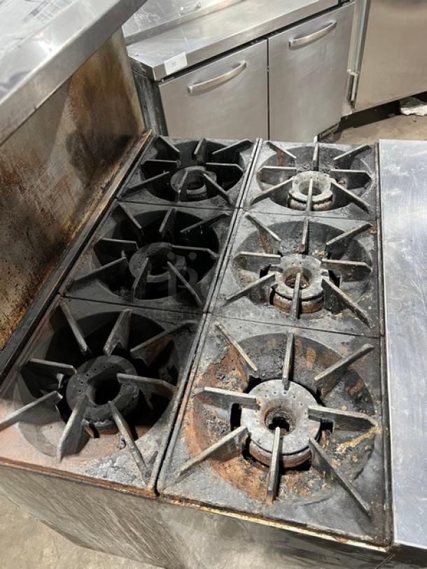 Royal Commercial 6-burner stainless steel gas range/oven. Includes backsplash, salamander shelf, wired oven rack, on casters. Model RR6.