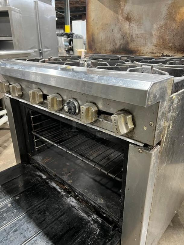 Royal Commercial stainless steel 6-burner range/oven model RR-6. Features backsplash, salamander shelf, wired oven rack, on casters. Used condition.