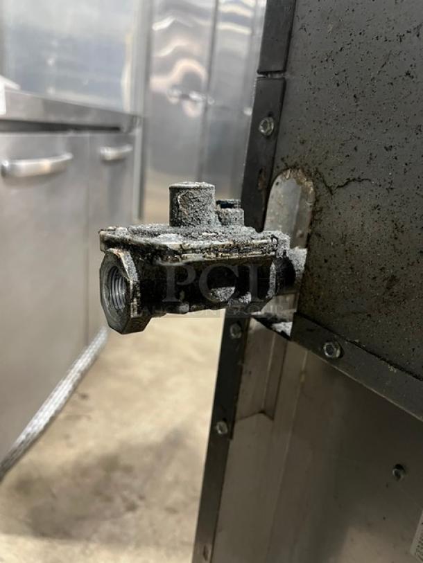 Royal RR6 commercial gas valve, showing a close-up of natural gas connection on a stainless steel 6-burner range. Condition appears used.