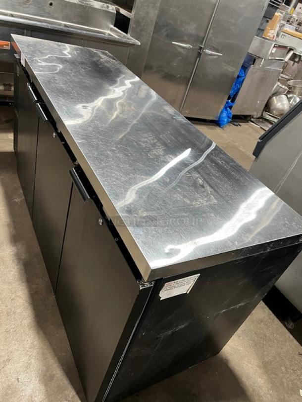 Continental BB79N black 3-door back bar refrigerator, stainless steel worktop, poly coated wired rack, excellent condition.