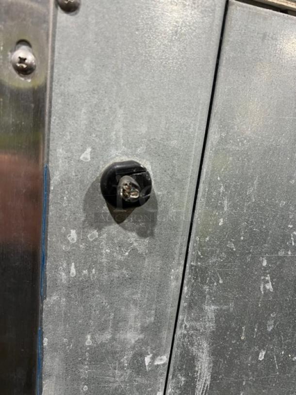 Hoshizaki Serenity Series ice machine, stainless steel finish, model DKM-500BAH, shows surface wear and lock mechanism.