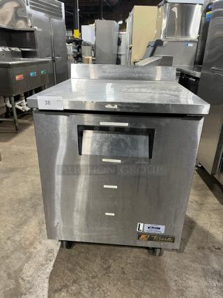 True TWT-27F stainless steel worktop freezer with up-turned backsplash, poly coated rack, on casters. Serial: 7644121.