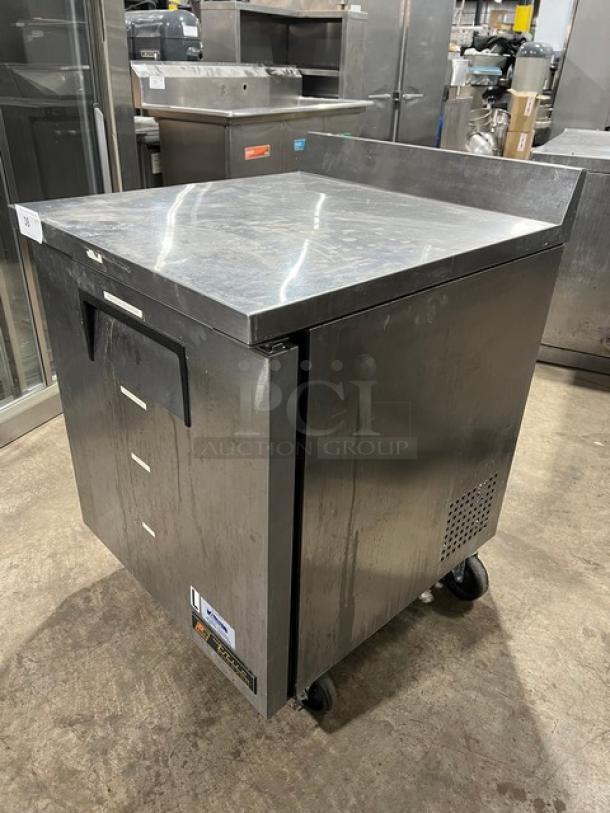 True TWT-27F commercial stainless steel worktop freezer with upturned backsplash, poly-coated rack, model TWT27F, on casters.