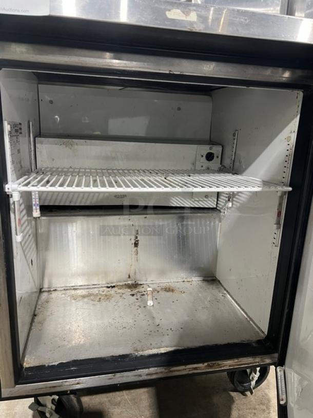 True TWT27F stainless steel worktop freezer, single door, 27-5/8", with up-turned backsplash, poly-coated rack, on casters.