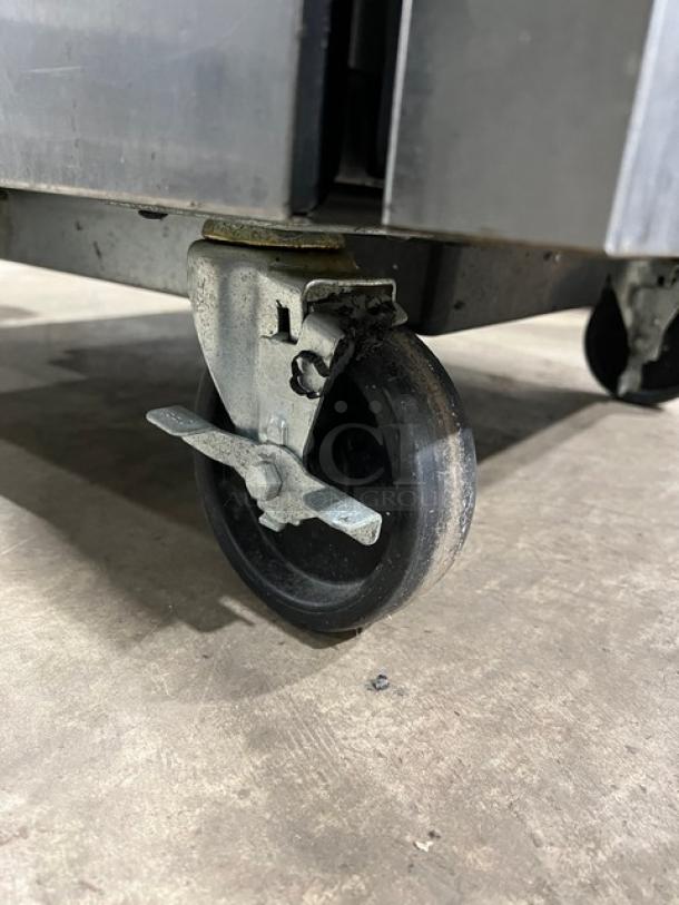 True TWT-27F stainless steel freezer wheel on caster, showing mobility feature and grounded condition.